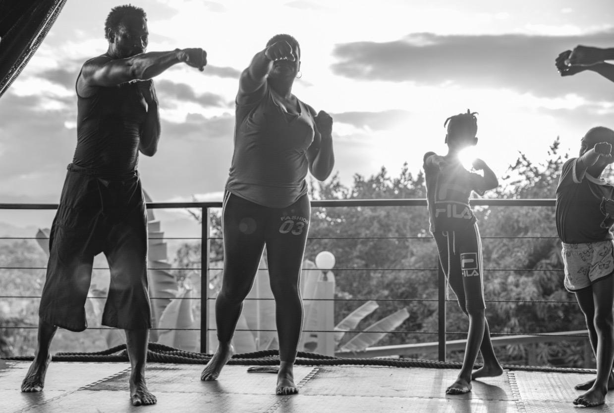 Black and white silhouettes of group training at sunset