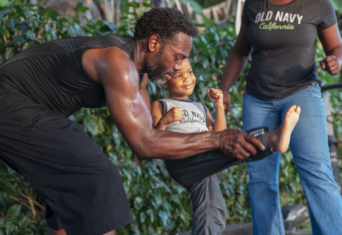 Eugene holding and playing with a small child