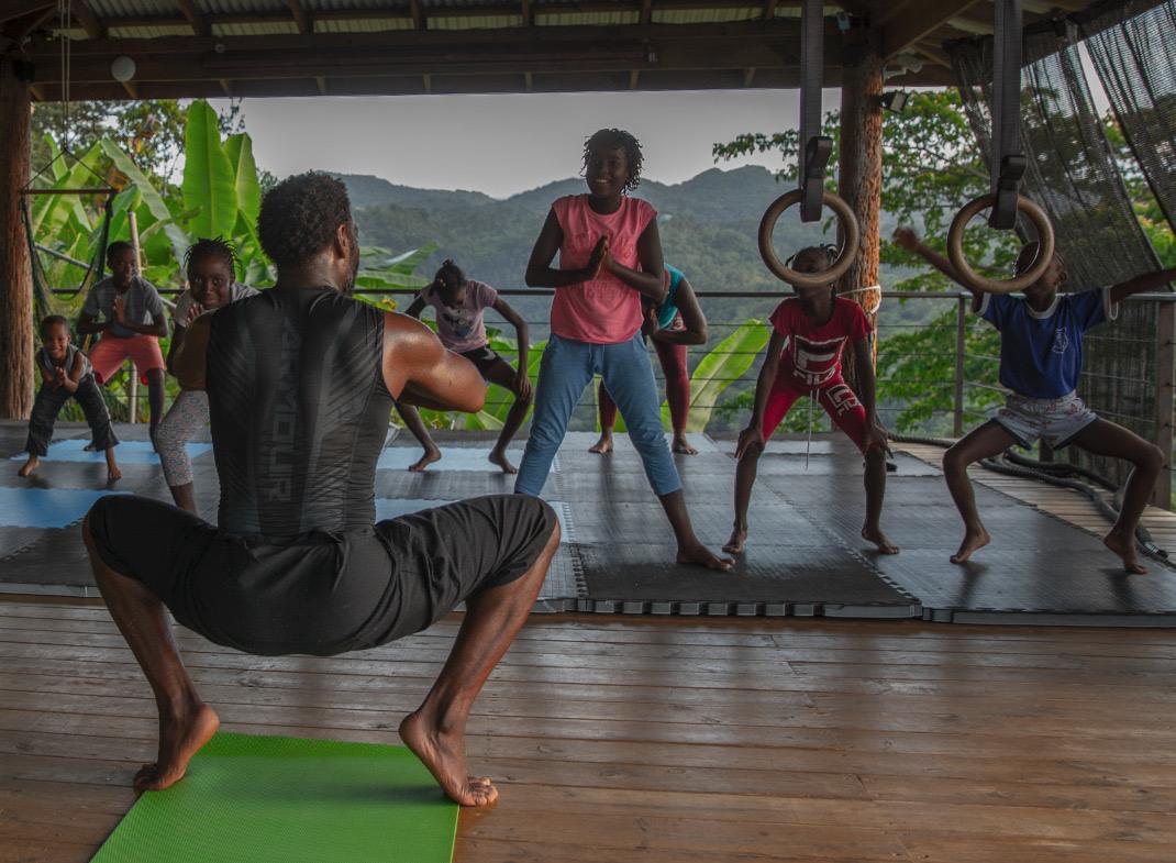 Wide shot of Eugene leading a group training session in Jamaica